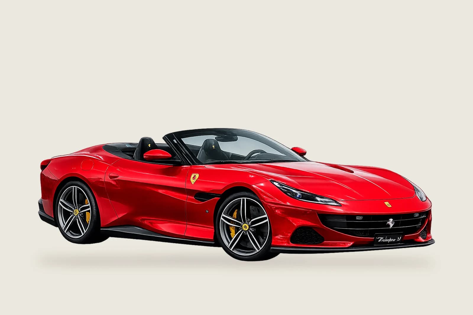 Red Ferrari Portofino M with the roof down seen from the side