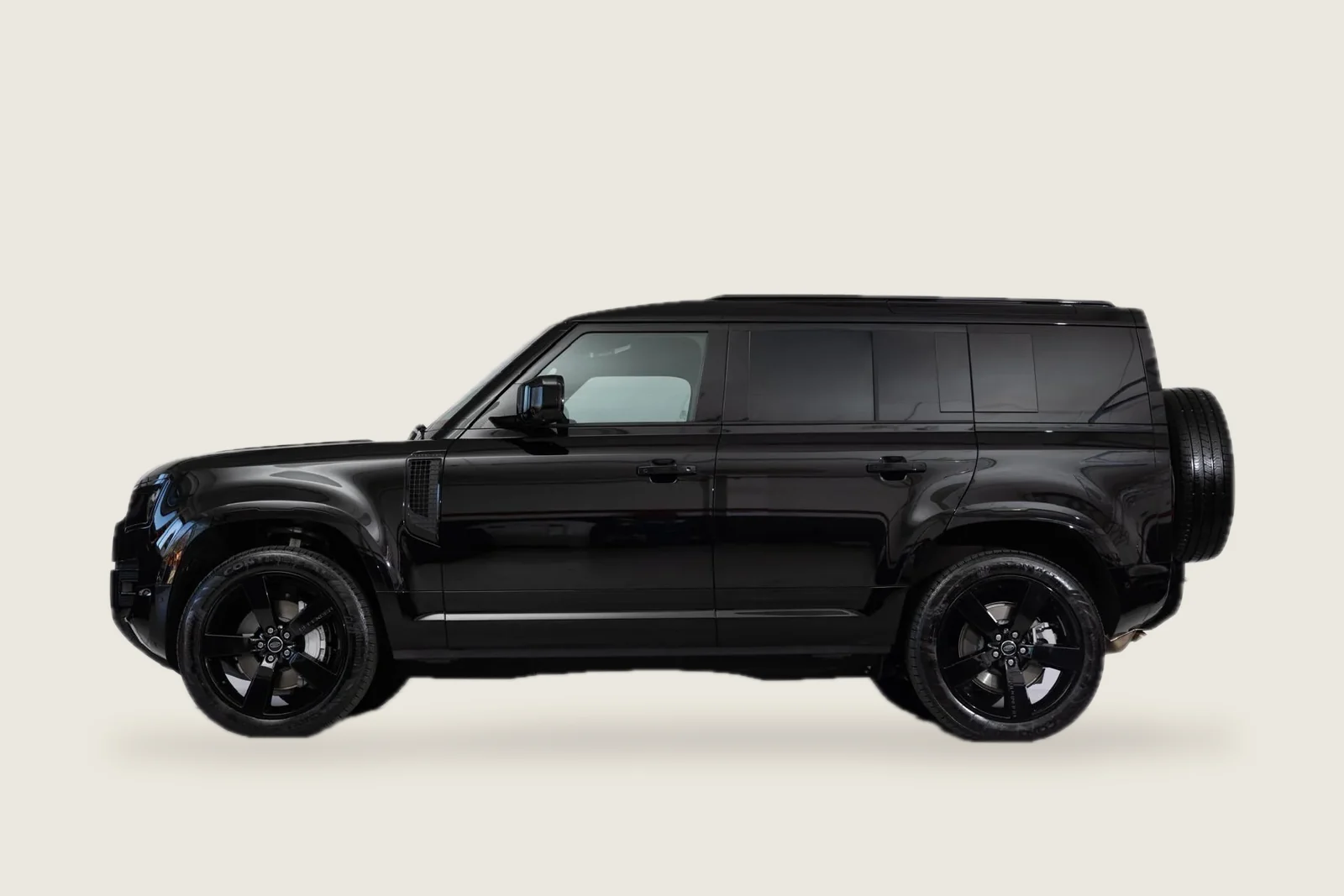 Black Land Rover Defender 110 seen from the side
